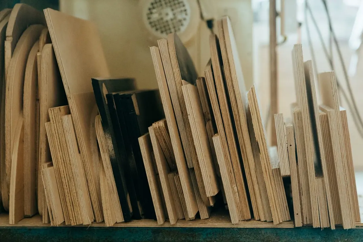 Plywood and MDF panels stacked in a casegoods workshop showing board core layers