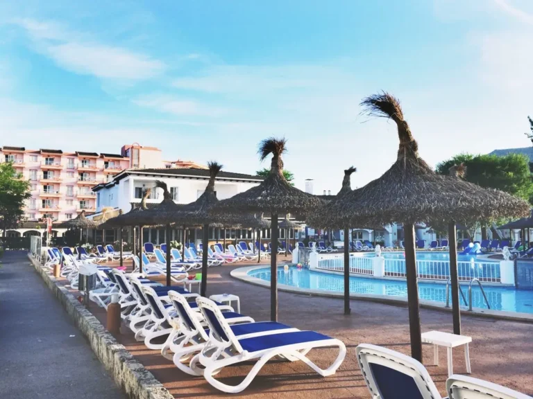 Resort poolside sun loungers and umbrellas from a resort FF&E sourcing China package