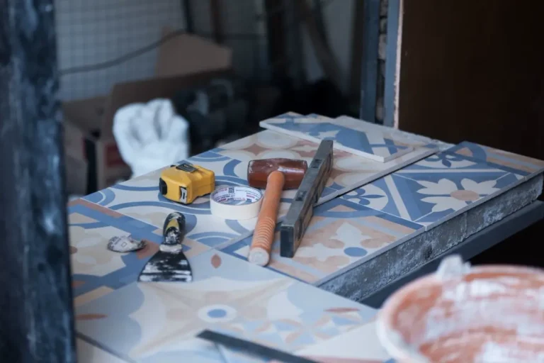 Patterned tiles and installation tools showing wastage allowance planning on a commercial project
