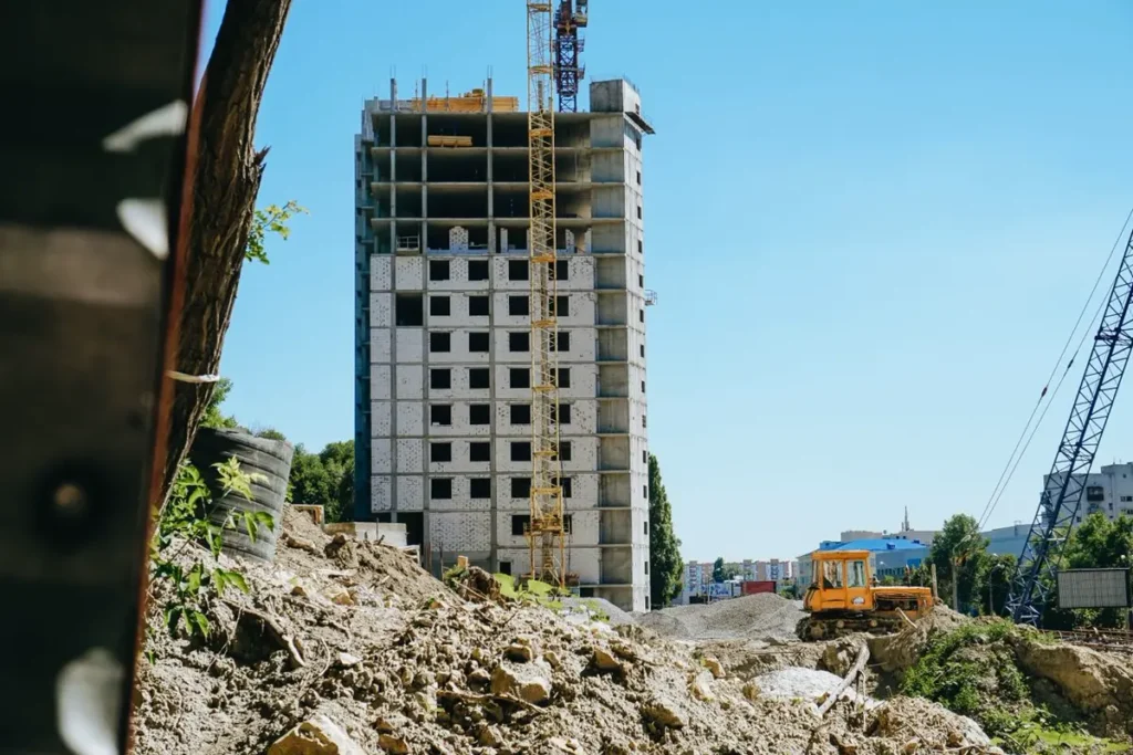 Mid-rise commercial building under construction with tower crane, illustrating US general contractors buying building materials from China