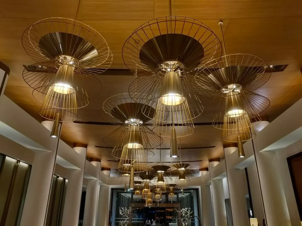 Feature pendant lighting in a hotel lobby, illustrating voltage and electrical standards for lighting sourced from China