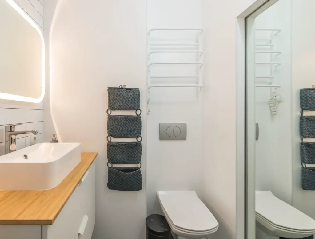 Wall-hung toilet with concealed cistern and flush plate in a modern commercial bathroom