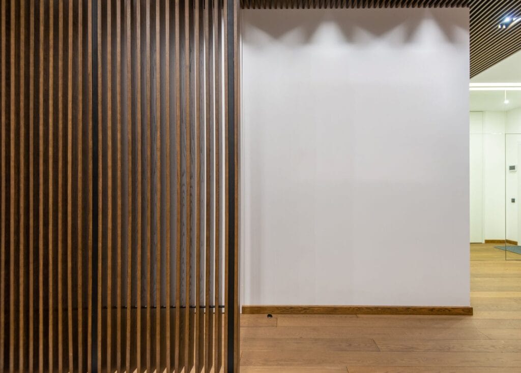 Slatted timber acoustic wall panels lining a commercial corridor