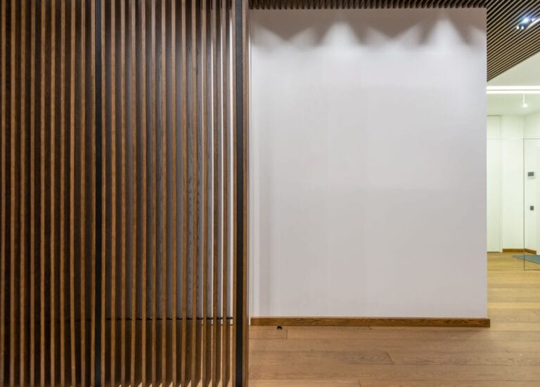 Slatted timber acoustic wall panels lining a commercial corridor