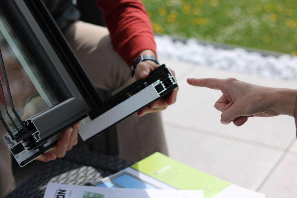 Aluminium window frame being examined on site, illustrating aluminum vs steel windows for commercial projects