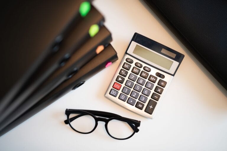 Calculator and project folders on a desk