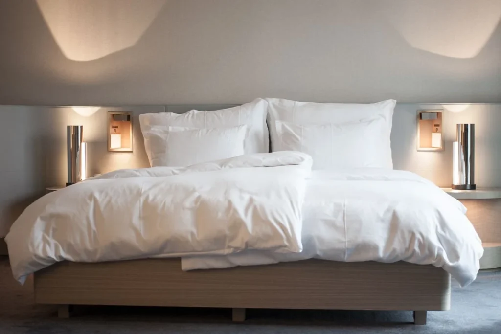 Hotel bed made up with mattress, duvet and pillows, the three separate supply chains behind a hotel bedding package sourced from China