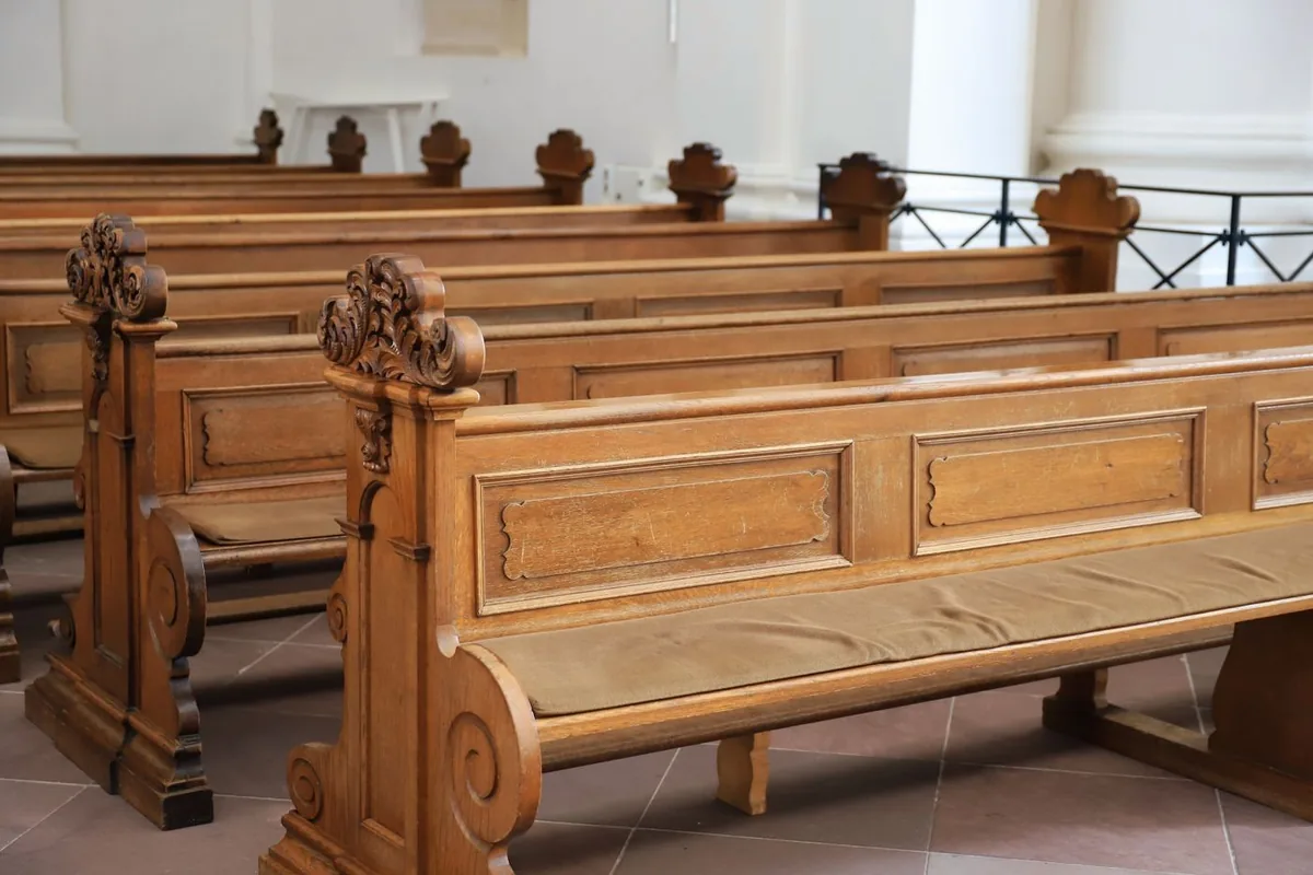 Carved timber pews in a worship building, representing seating and finishes for church and worship centre projects