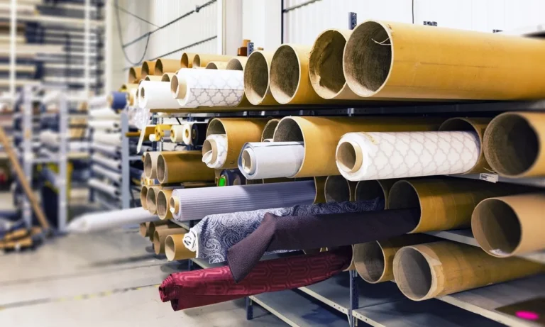 Rolls of upholstery fabric racked in a textile facility, the customer own material supplied under a COM or COL contract upholstery order from China