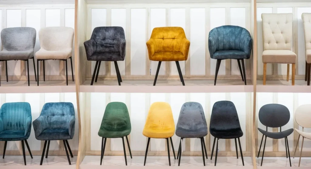 Chairs displayed on retail showroom shelving, contrasting retail buying with commercial furniture sourcing for construction projects
