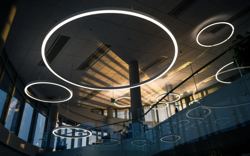 Circular LED pendant lighting scheme in a commercial building, the type of fixture package a commercial lighting brief specifies