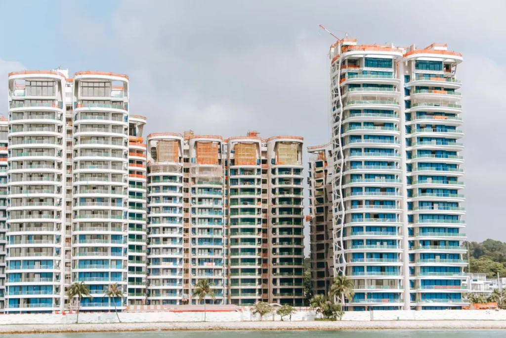 Coastal high-rise residential towers with full-height windows and balconies