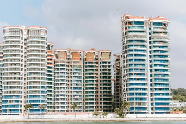 Coastal high-rise residential towers with full-height windows and balconies