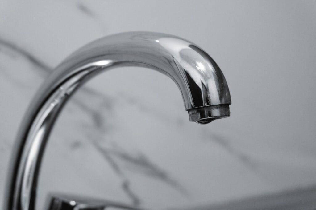 Chrome basin faucet against marble, illustrating faucet and tapware manufacturers in China for commercial projects
