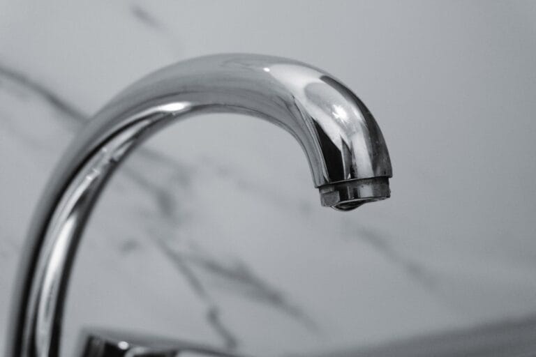 Chrome basin faucet against marble, illustrating faucet and tapware manufacturers in China for commercial projects