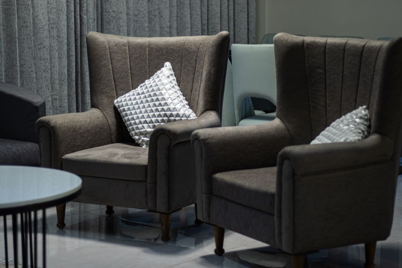 Upholstered lounge armchairs in a hotel public area