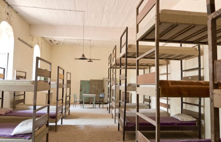 Metal bunk beds in a hostel dormitory room