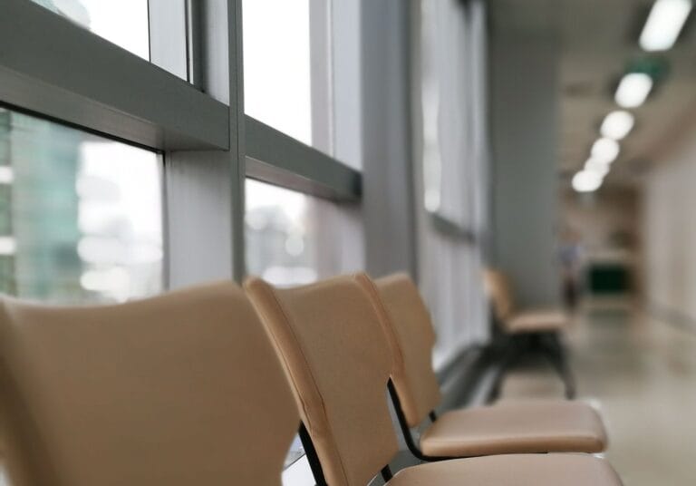 Beam seating along a healthcare facility corridor
