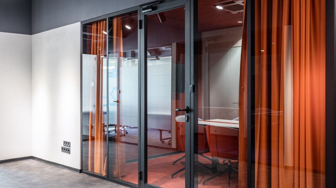 Glass-fronted acoustic meeting pod in an open-plan office