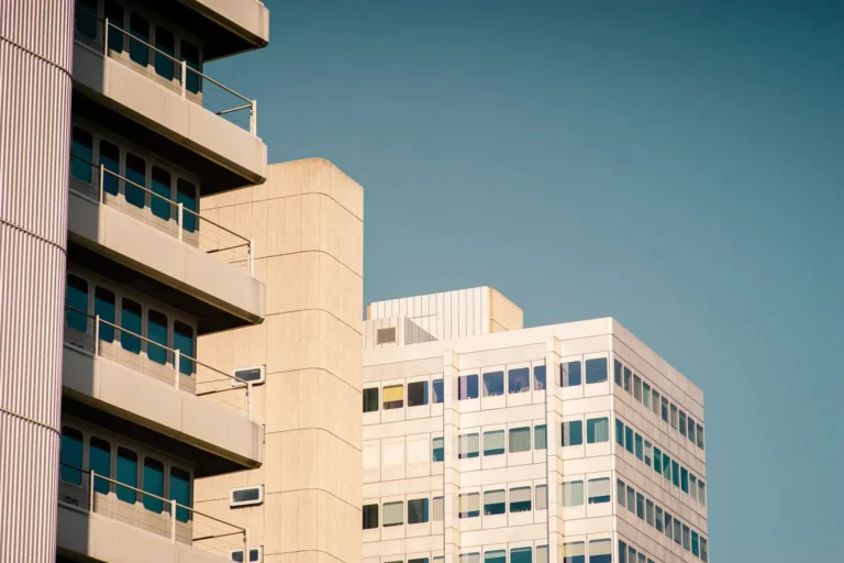 Office building beside residential apartment block with balconies, office to residential conversion