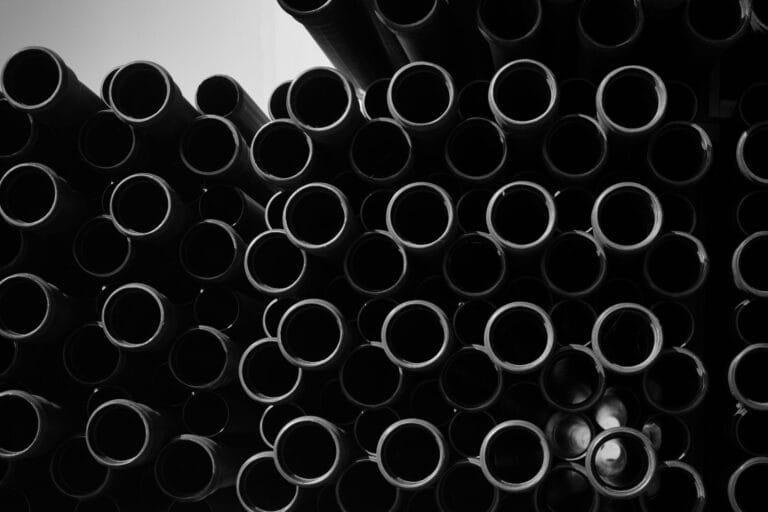 Stacked plastic pipe ends seen head-on, representing PP-R pipe supply for building projects