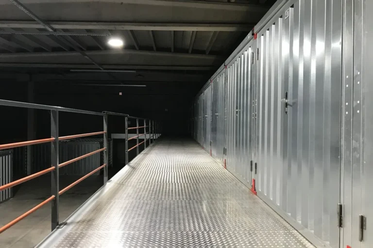 Self-storage mezzanine corridor lined with steel partition units and unit doors