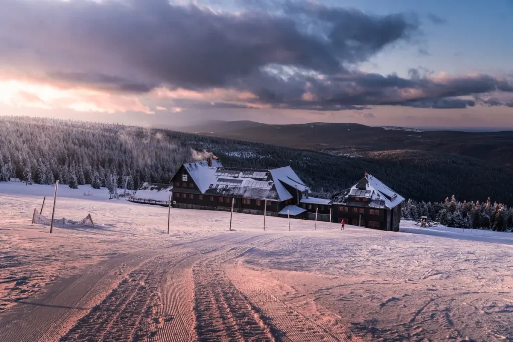 Snow-covered mountain lodge representing ski resort FF and E and building materials sourced from China