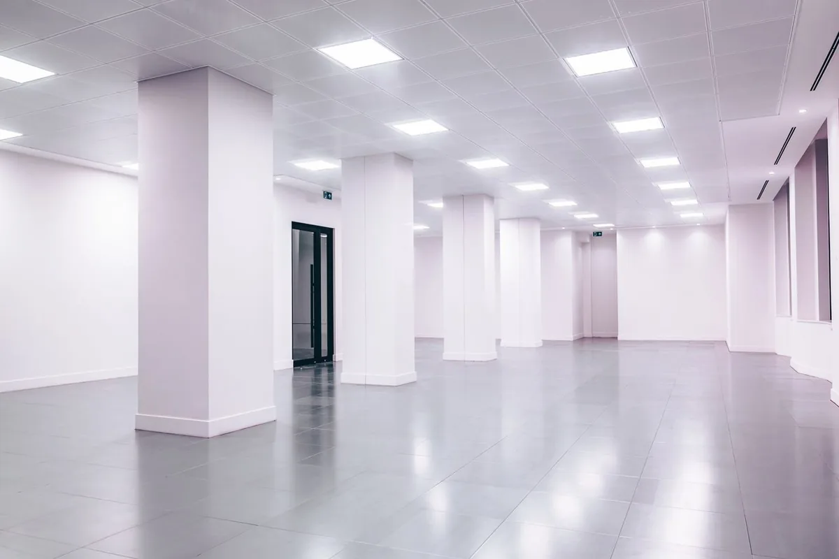Large-format porcelain floor tiles in an empty commercial space, representing tile specification for Australian commercial projects