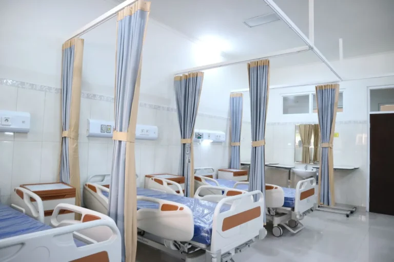Hospital ward with electric hospital beds and privacy curtains in a healthcare project