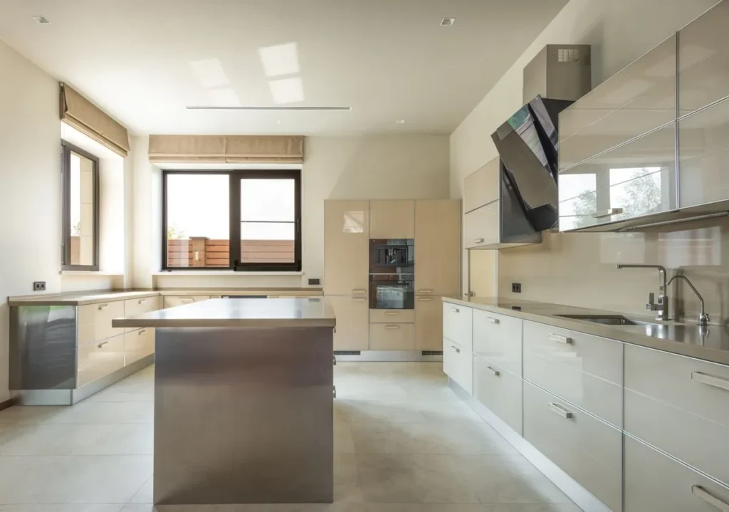 Modern condo kitchen with gloss cabinets, island and full-height tall units