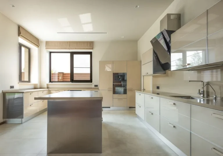 Modern condo kitchen with gloss cabinets, island and full-height tall units