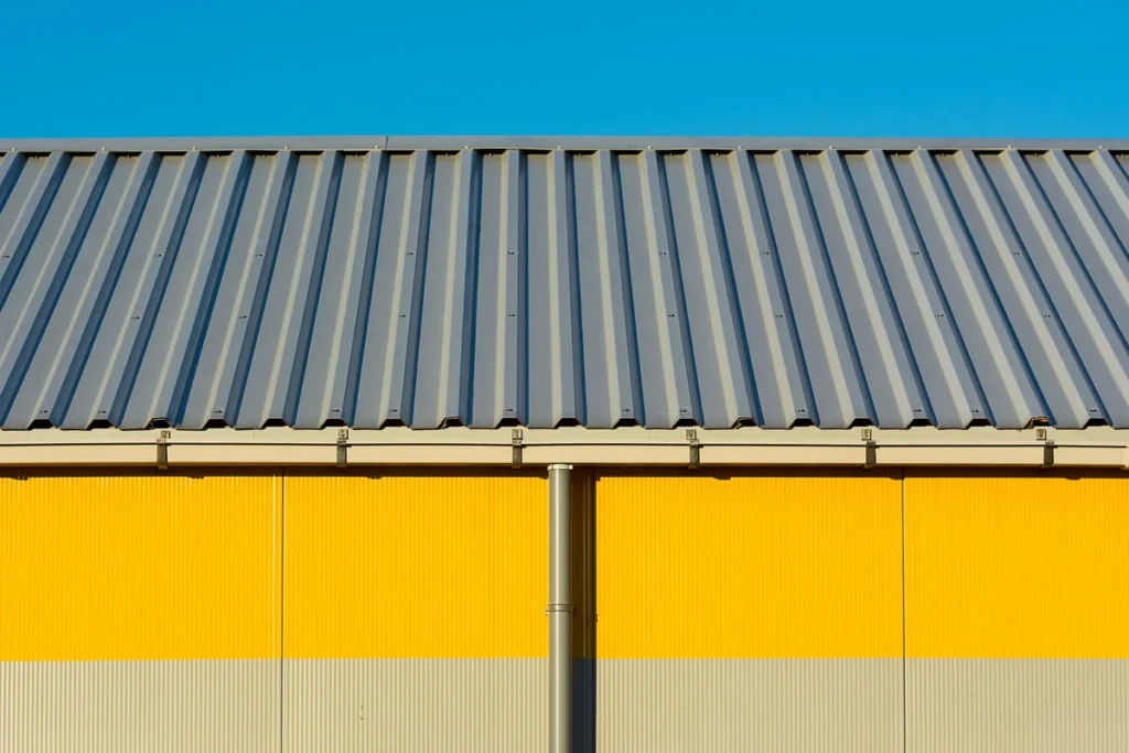 Profiled metal roof sheets on an industrial building with coated steel wall cladding