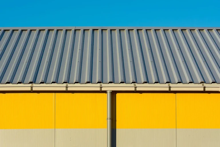 Profiled metal roof sheets on an industrial building with coated steel wall cladding
