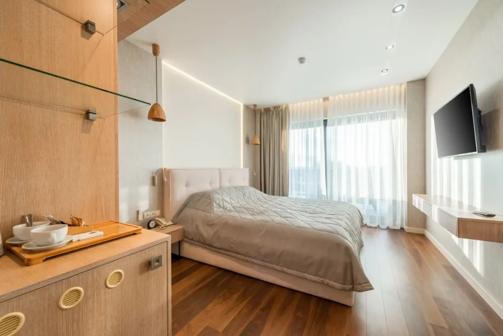 Hotel guest room with wood-look plank flooring used in multifamily and hotel projects