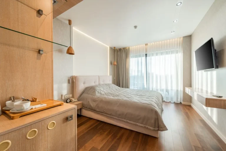 Hotel guest room with wood-look plank flooring used in multifamily and hotel projects