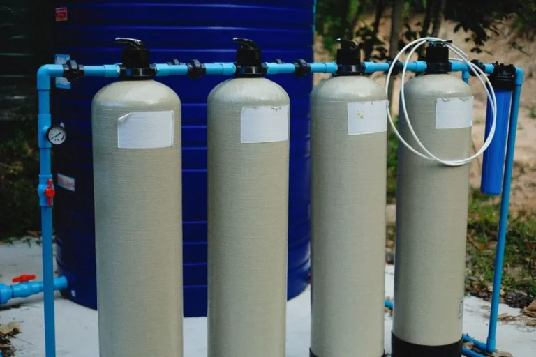 Beige water treatment tanks connected with blue piping
