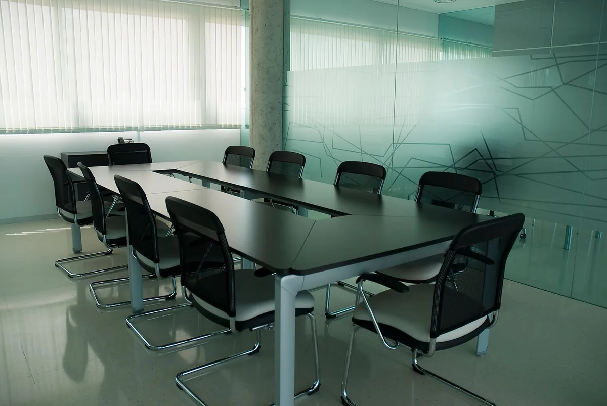 Conference room with black chairs behind a glass wall