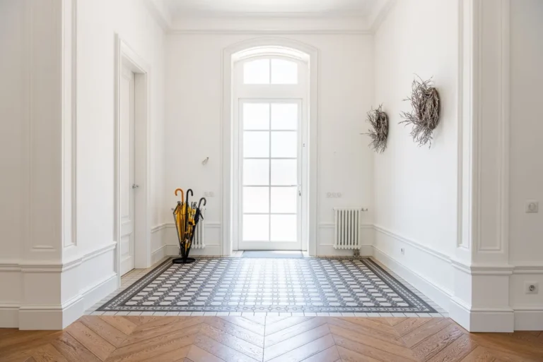 Hallway with parquet flooring and a tiled inset