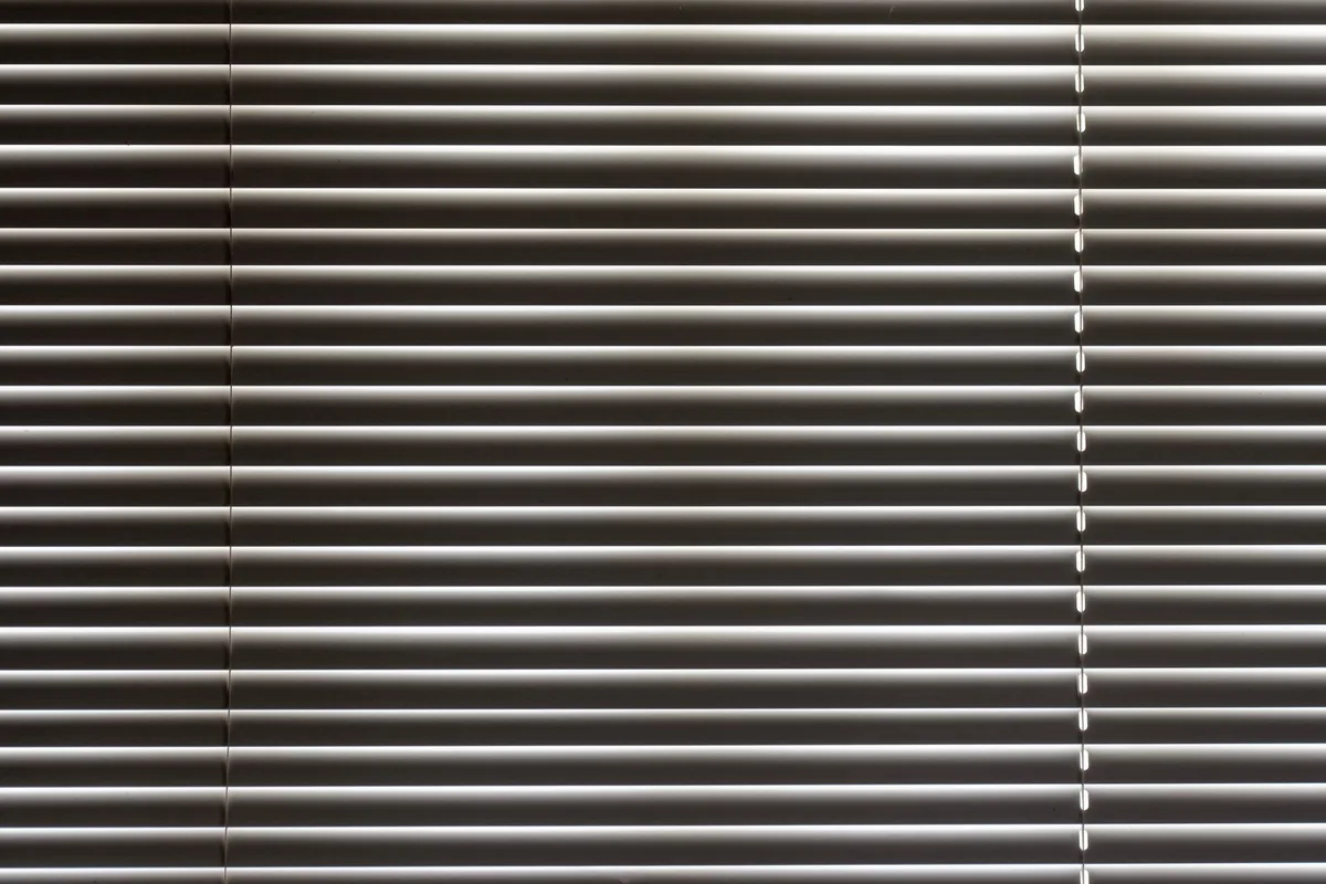 Close-up of horizontal metal window blinds