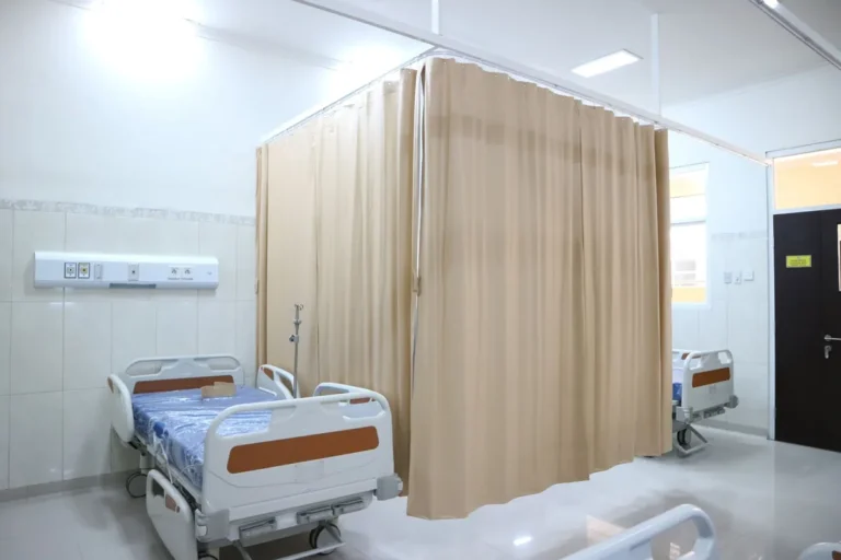 Hospital ward with beds and privacy curtains