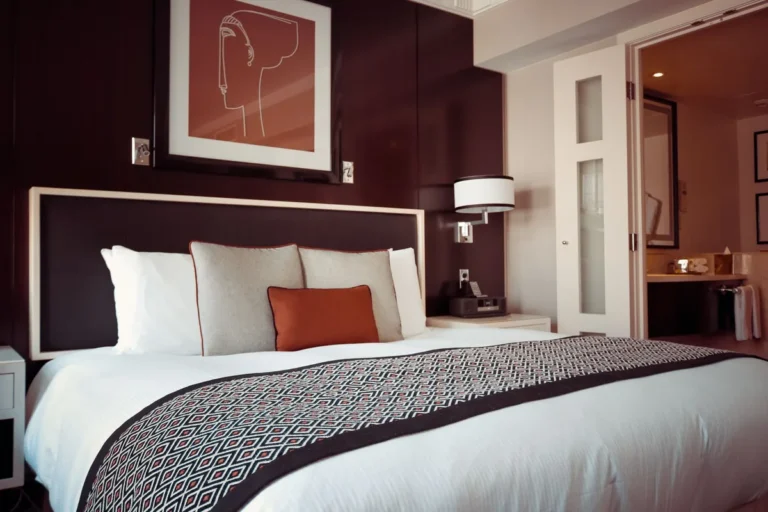 Hotel bedroom with a double bed, headboard, white bedding and bedside lamps