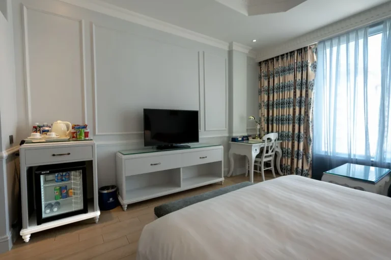 Hotel bedroom with a minibar built into the unit under the television