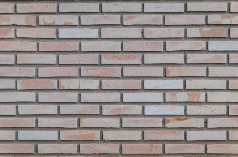 Pale facing brick wall laid in stretcher bond with thin mortar joints