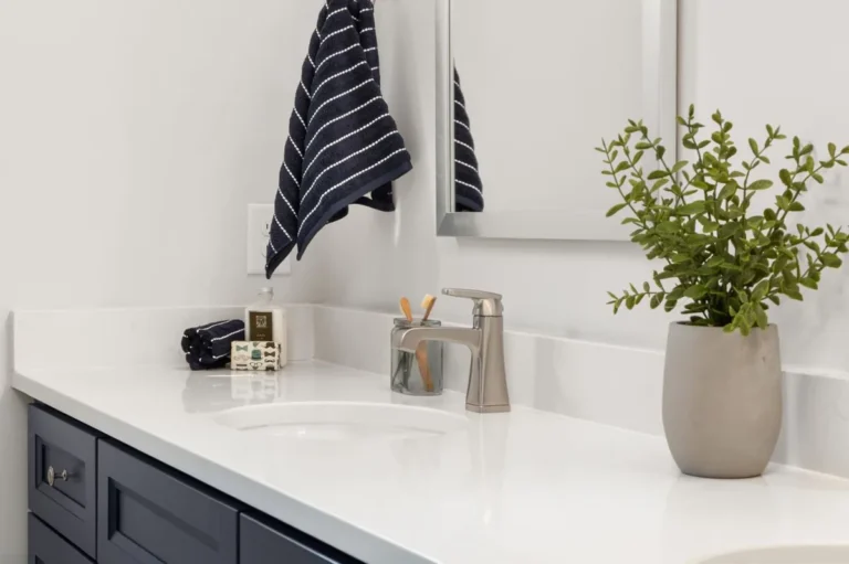 White solid surface style vanity counter with an integrated basin in a bathroom