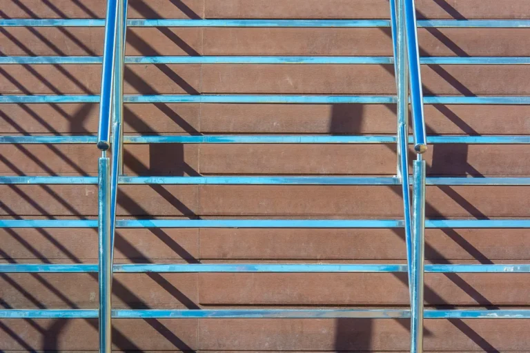 Staircase with metal railings and wooden steps