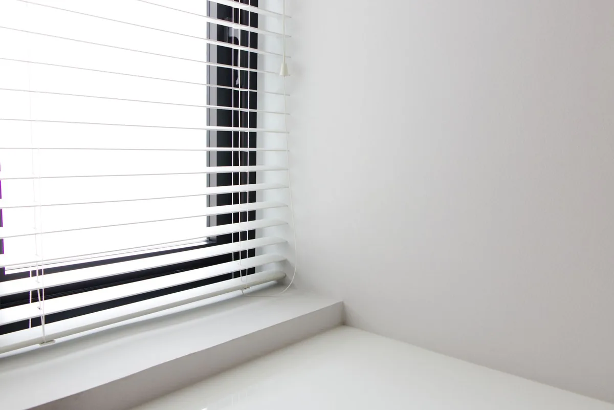 White window blinds in a bright room