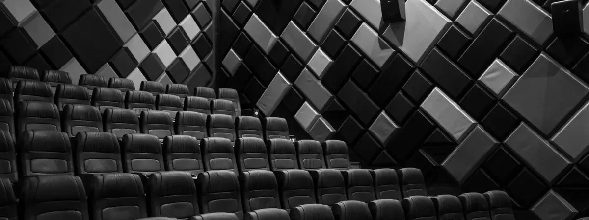 Fabric acoustic wall panels installed in a commercial cinema auditorium for sound absorption