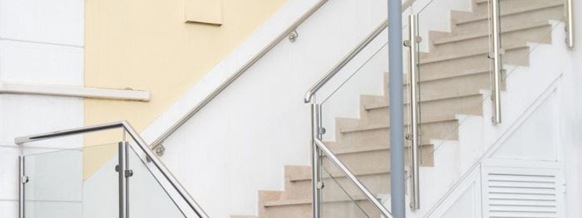 A stylish interior staircase with glass railings in a modern building.