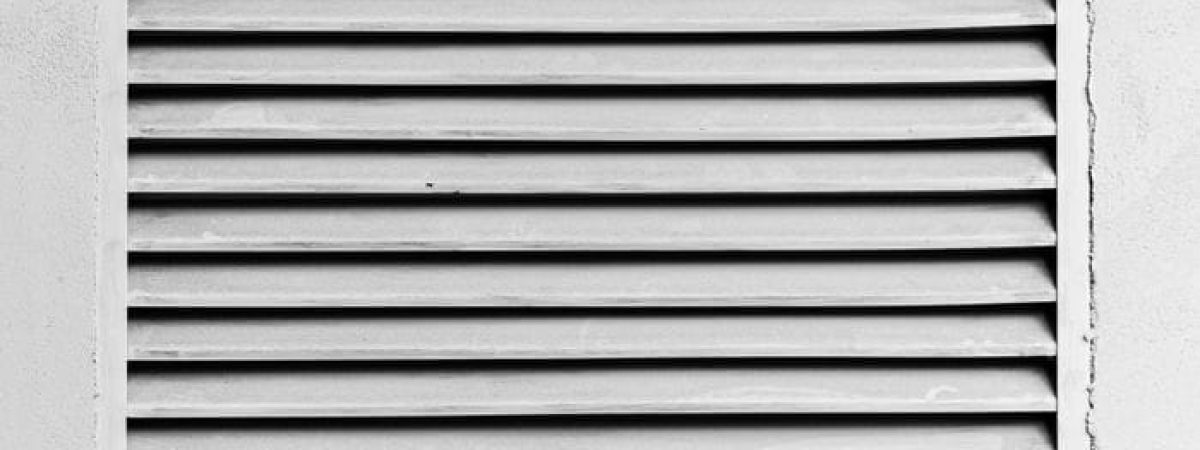 Black and white photo of louvered panel showcasing high contrast lines and textures.