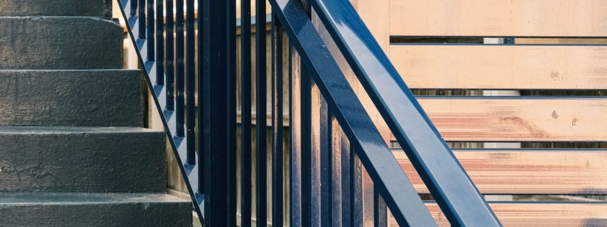 Elegant staircase design featuring modern railings and wooden paneling details.